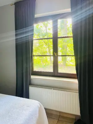 a bedroom with a bed and a window at Zenitude in Tremelo