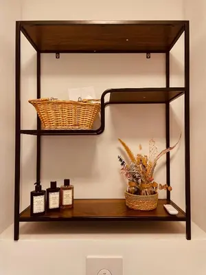 a shelf with bottles and a basket on a wall at Zenitude in Tremelo