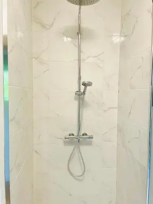 a shower with a shower head in a bathroom at Zenitude in Tremelo