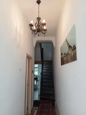 a hallway with a chandelier and a staircase in a house at Tomorrowlandhome Boom in Boom