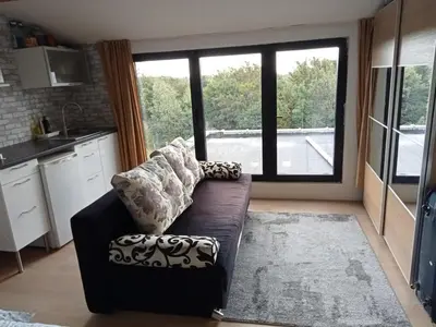 a living room with a couch and a large window at Tomorrowlandhome Boom in Boom