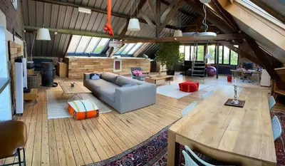a large living room with a couch and a table at The Urban Loft in Brussels West in Brussels