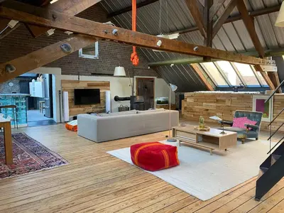 a large living room with a couch and a table at The Urban Loft in Brussels West in Brussels