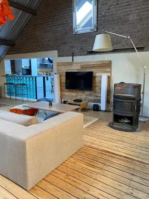 a living room with a couch and a stove at The Urban Loft in Brussels West in Brussels