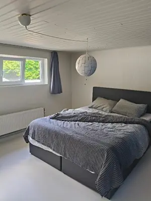 a bedroom with a bed with a blue comforter at Ontferming RwinteR in Mol