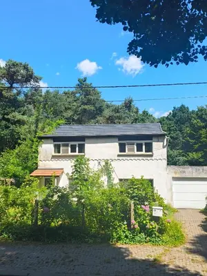 a white brick house with a garage at Ontferming RwinteR in Mol