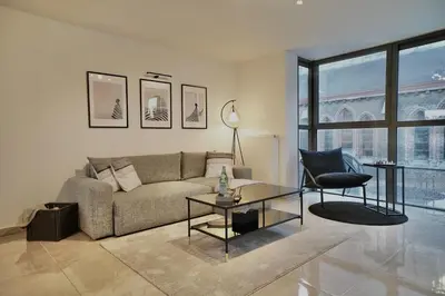 a living room with a couch and a table at Chic Loft Facing Neo-Gothic Church in Ghent