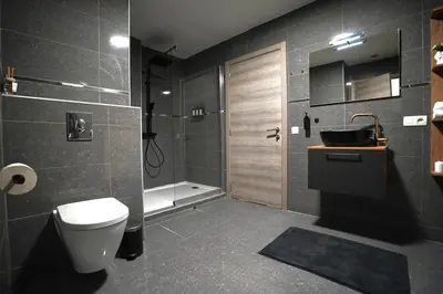 a bathroom with a toilet and a sink and a shower at Chic Loft Facing Neo-Gothic Church in Ghent