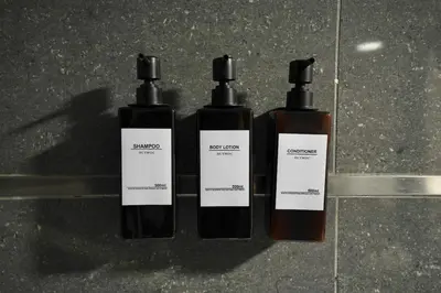 three bottles of soap sitting on a counter at Chic Loft Facing Neo-Gothic Church in Ghent