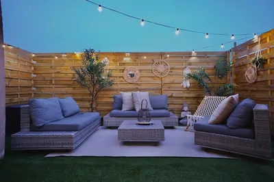 a patio with two couches and a table and a blue light at Chic Loft Facing Neo-Gothic Church in Ghent