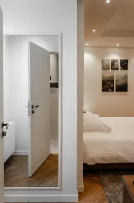 a bedroom with a door leading to a bed at Il Ponte Private Room with Hotel-Style Comfort in Ghent