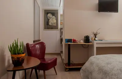 a room with a bed and a table and a chair at B&B Tspijker in Mol