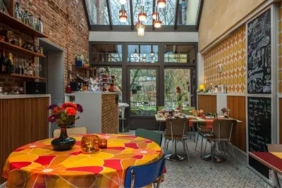 a restaurant with a table and chairs in a room at B&B Tspijker in Mol