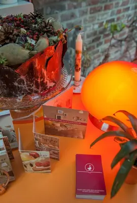 a table topped with a bowl of plants and a candle at B&B Tspijker in Mol