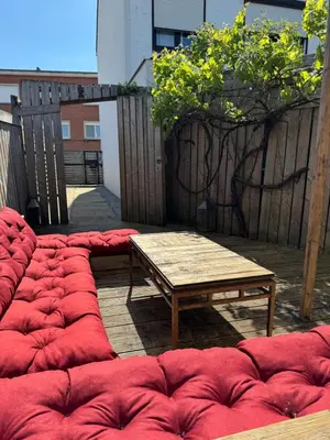 a group of red bean bags sitting next to a table at Loft Cosy avec billard et à 10 minutes de l'aéroport de Zaventem in Machelen