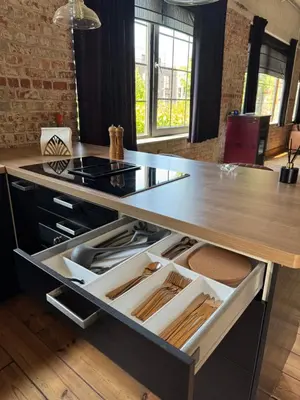 a kitchen with a counter with an open drawer at Loft Cosy avec billard et à 10 minutes de l'aéroport de Zaventem in Machelen