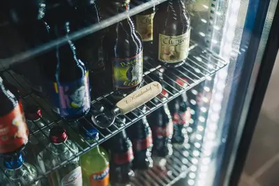 a refrigerator filled with lots of bottles of beer at B&B 't Kruidenhof in Assenede