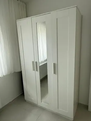 a white cabinet in a room with a window at Beautiful house &parking space in Leuven
