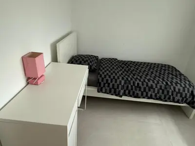 a bedroom with a bed and a dresser and a desk at Beautiful house &parking space in Leuven