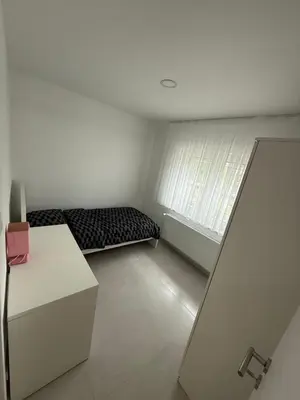 a small room with a bed and a window at Beautiful house &parking space in Leuven