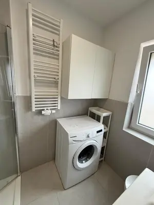 a small kitchen with a washing machine in it at Beautiful house &parking space in Leuven
