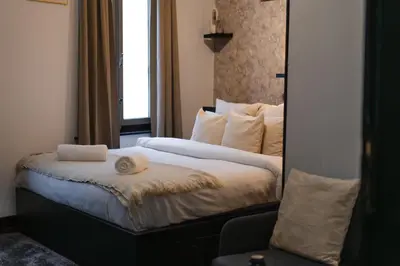 a bedroom with a bed with a mirror at Spacious & Stylish 3 adjacent Bedrooms Stay in Central Ghent in Ghent