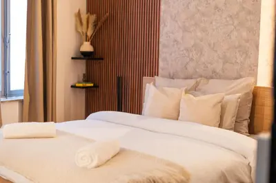a bedroom with two beds with white sheets and pillows at Spacious & Stylish 3 adjacent Bedrooms Stay in Central Ghent in Ghent