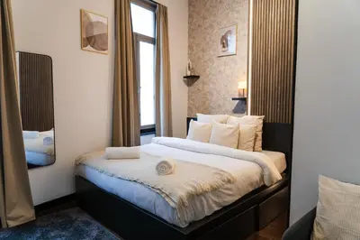 a bedroom with a large bed with a window at Spacious & Stylish 3 adjacent Bedrooms Stay in Central Ghent in Ghent