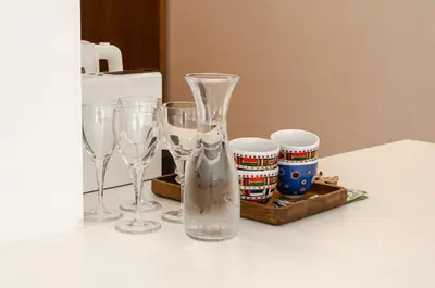 a group of wine glasses and a vase on a counter at Bellavista Luxe Apartment with Leie View in Ghent