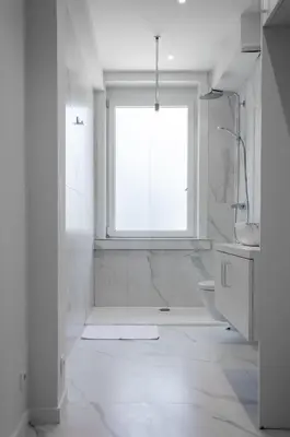 a white bathroom with a window and a sink at Bellavista Luxe Apartment with Leie View in Ghent