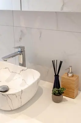 a bathroom with a white marble sink on a counter at La Veduta - Luxe Apartment with Leie View in Ghent