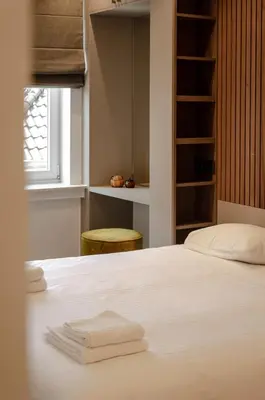 a bedroom with a bed with two towels on it at La Veduta - Luxe Apartment with Leie View in Ghent