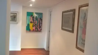 a hallway with paintings on the walls of a room at Bvba Bacana in Rotselaar