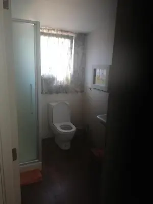 a small bathroom with a toilet and a window at Bvba Bacana in Rotselaar