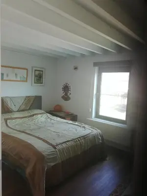 a bedroom with a bed and a window at Bvba Bacana in Rotselaar