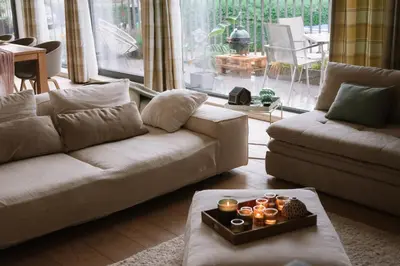 a living room with a couch and a table at La Petite Foret Contemporary Apartment in Halle in Halle