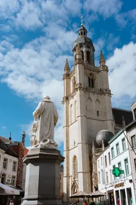 a statue in front of a building with a tower at La Petite Foret Contemporary Apartment in Halle in Halle