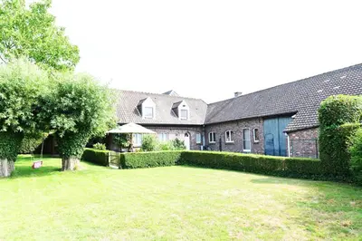 a large house with a yard in front of it at Vakantiewoning Nijkenhof in Ninove