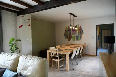 a dining room with a wooden table and chairs at Vakantiewoning Nijkenhof in Ninove