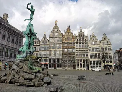 a statue in the middle of a city with buildings at Belgielei business apartment in Antwerp