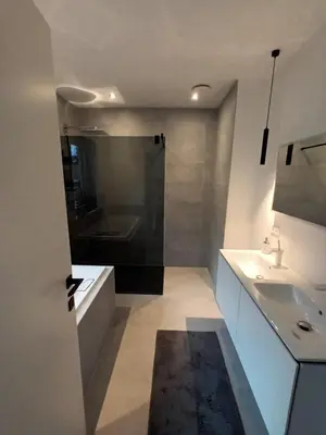 a bathroom with a tub and a sink and a shower at TML House in Boom