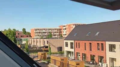 a view from a window of a city with buildings at TML House in Boom