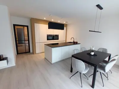 a kitchen and dining room with a table and chairs at TML House in Boom