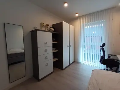 a bedroom with a mirror and a dresser and a bed at TML House in Boom