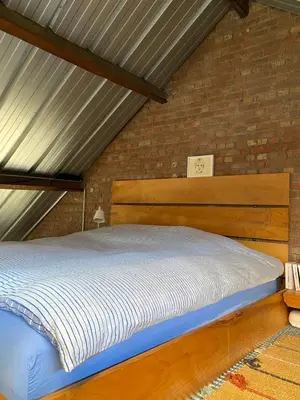 a bed in a room with a brick wall at Urban Loft in Brussels West in Brussels