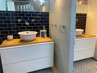 a bathroom with two sinks and a mirror at Urban Loft in Brussels West in Brussels