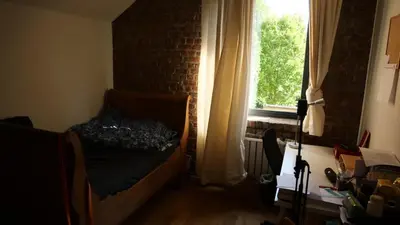 a bedroom with a bed in front of a window at Urban Loft in Brussels West in Brussels