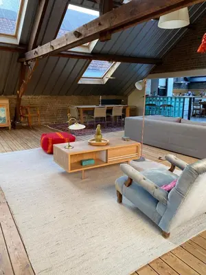 a living room with a couch and a table at Urban Loft in Brussels West in Brussels