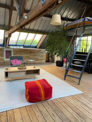 a living room with a red rug on the floor at Urban Loft in Brussels West in Brussels