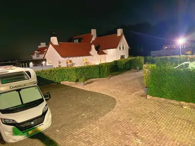 a white car parked in front of a house at Villa Grenszicht in Nispen